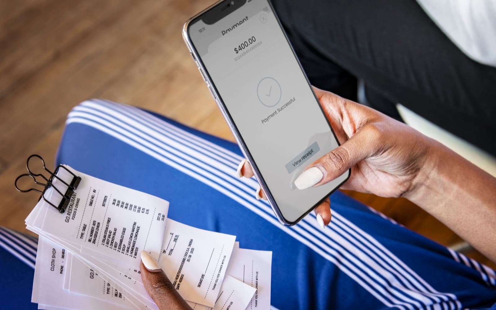 Mobile screen confirming a successful electronic payment beside receipts